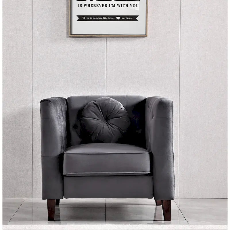 armchair with a cushion against a light gray wall with a framed quote.