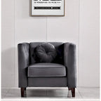 armchair with a cushion against a light gray wall with a framed quote.
